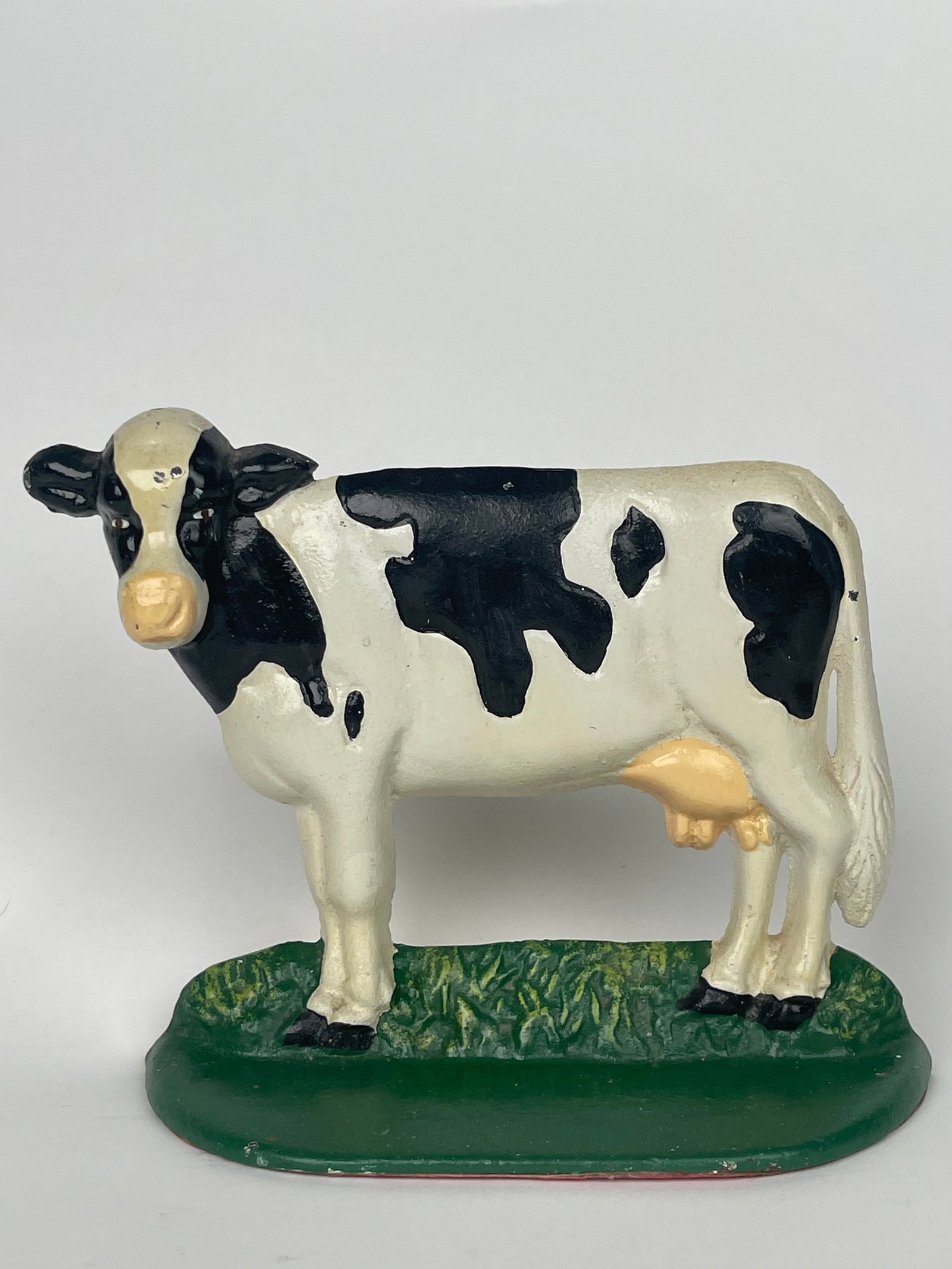 A Cast Iron Farm Cow Doorstop: A Cast Iron Farm Cow Doorstop. H: 5-1/2” W:7”