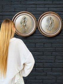 Pair of Patinated Bronze Cupid Reliefs in Round Wooden Frames