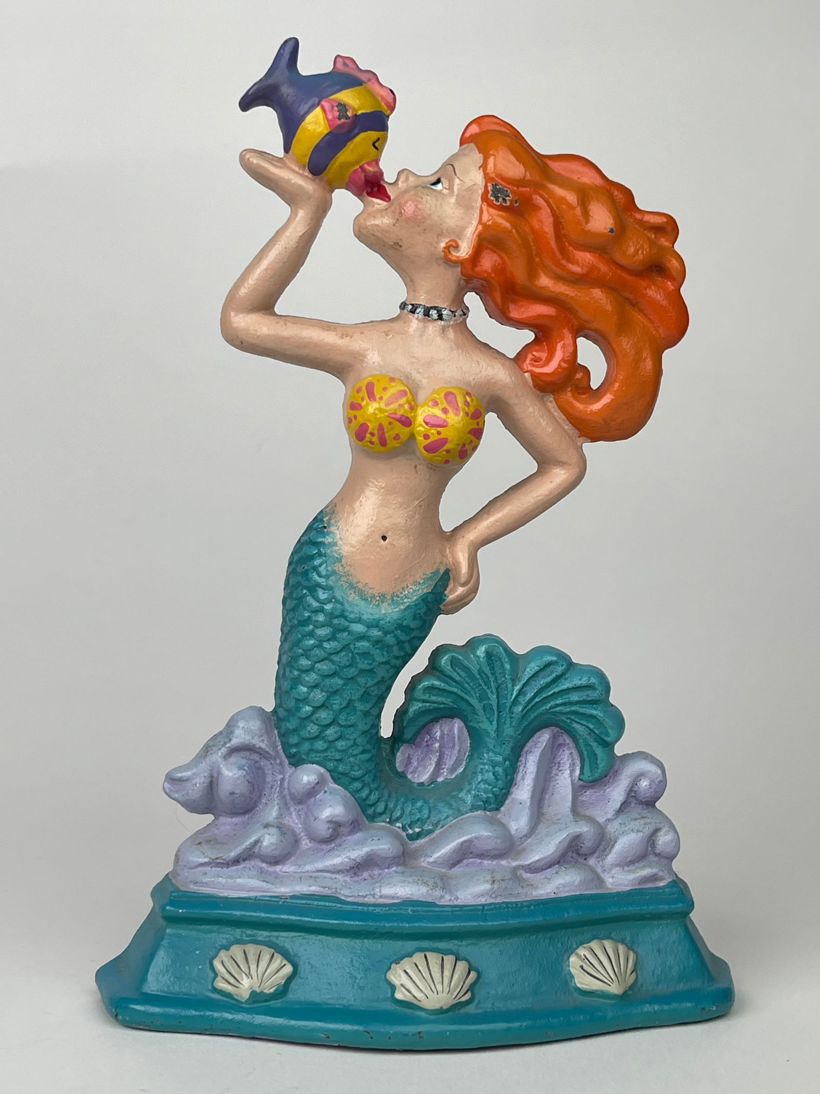 A Cast Iron Orange Hair Mermaid Kissing Fish Doorstop: A Cast Iron Orange Hair Mermaid Kissing Fish Doorstop. H: 9-1/8”W:6-1/4”