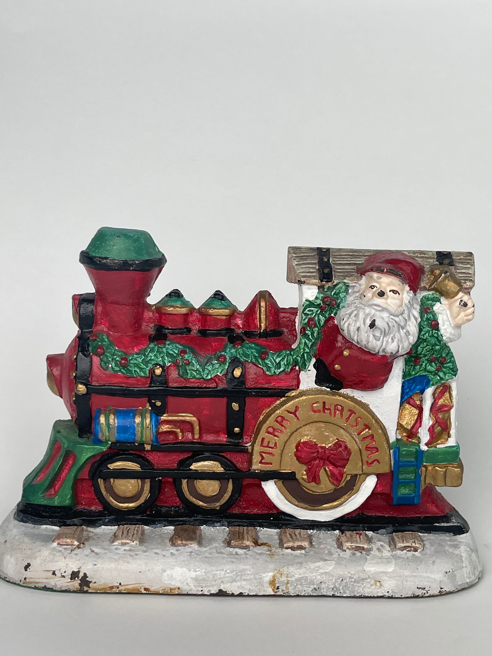 A Merry Christmas Express Train with Santa Claus Cast Iron Doorstop: A Merry Christmas Express Train with Santa Claus Cast Iron Doorstop. H: 5-1/2” W:8-1/2”