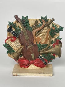 A Cast Iron Figure of Orchestral Instruments Doorstop