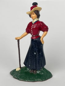 A Cast Iron Golfing Woman on a Grass Field Doorstop