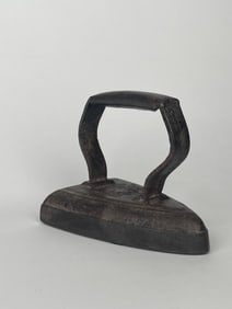 A Clothing Iron Made of Cast Iron Doorstop