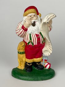 A Cast Iron Santa Claus Reading His List Doorstop