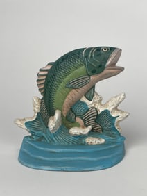 A Cast Iron Fish Swimming Through a Water Wave Doorstop