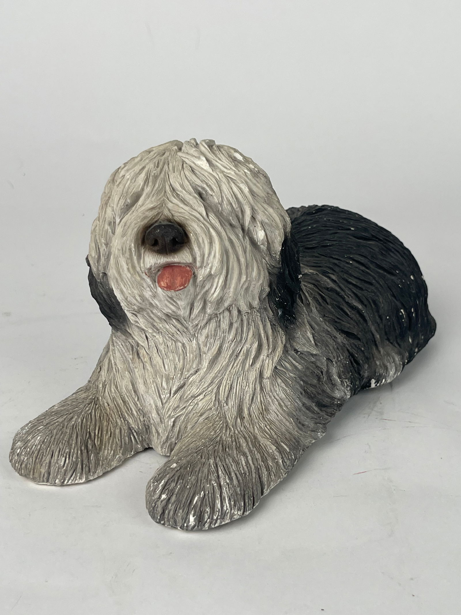 A SandiCast Hand Painted Pottery Seated Dog: A SandiCast Hand Painted Pottery Seated Dog. H: 5” W: 9”