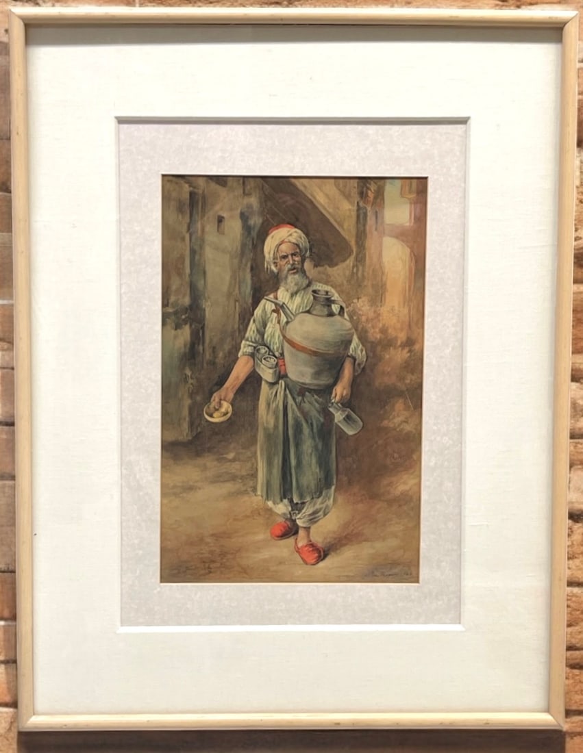 George Gregory (British 1849-1938): George Gregory (British 1849-1938). An Orientalist Water Color Painting. An Arab Man Selling Water. Circa 1944. Frame: 32”x 28