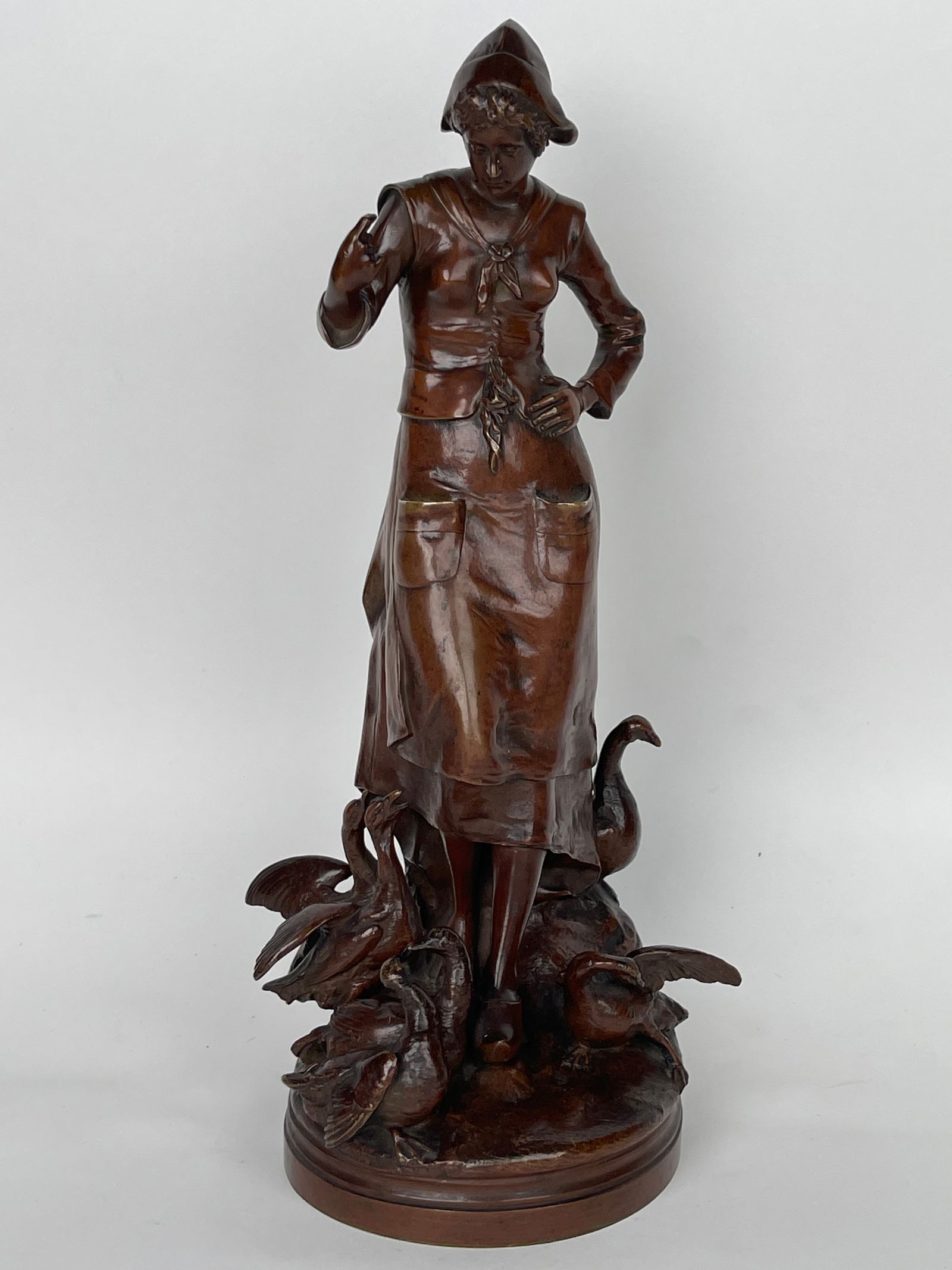 A Patinated Bronze Sculpture Of A Standing Lady Feeding Ducks By Lalouette: A Patinated Bronze Sculpture Of A Standing Lady Feeding Ducks By Lalouette. France, Circa 1880. Singed By the Artist. H: 14” D: 5”