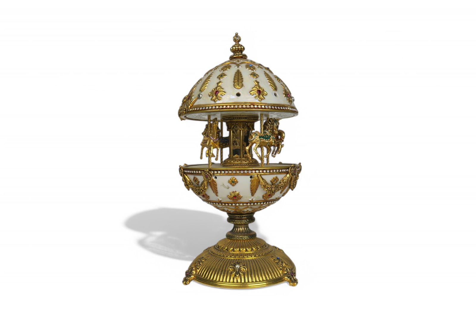 Franklin Mint House of Faberge; The Faberge Imperial Carousel Egg: Franklin Mint House of Faberge; The Faberge Imperial Carousel Egg, with a carousel that revolves to the sound of the musical box operated by the winding key finial-11"x4-3/4"