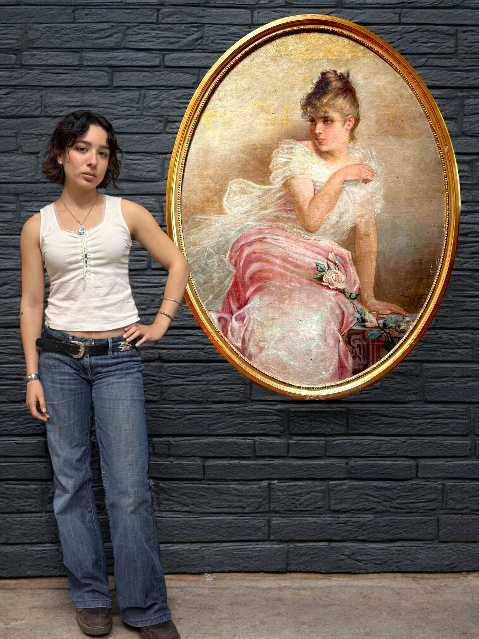 Vittorio Matteo Corcos (Italian, 1859-1933): Vittorio Matteo Corcos (Italian, 1859-1933).An impressive large-scale oval oil painting laid on canvas depicting a refined young woman seated in an elegant pose, dressed in a flowing pink gown