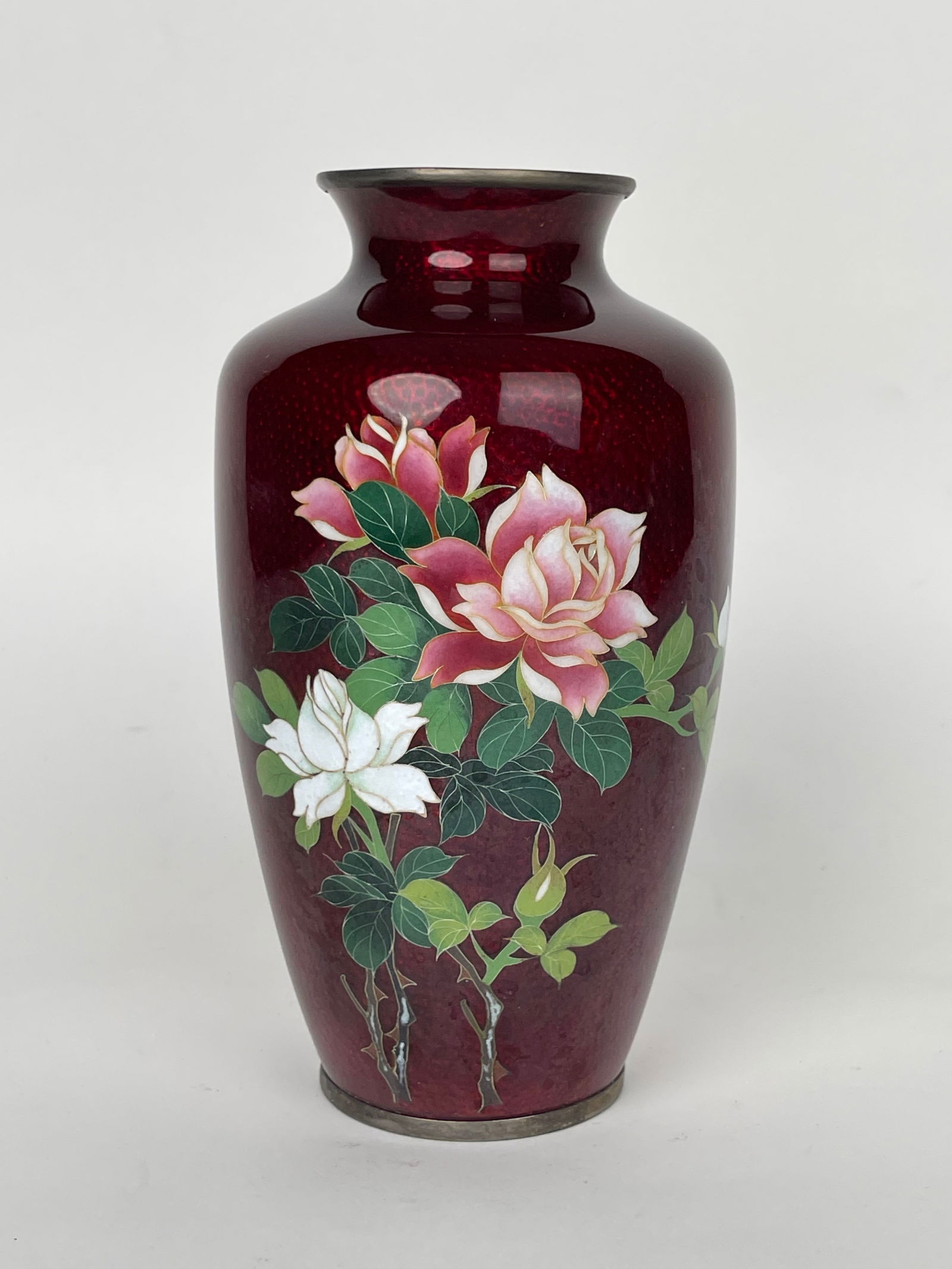 A Japanese Red Ground Enamel Vase With Roses: A Japanese Red Ground Enamel Vase With Roses. H: 7-1/2” D: 4-1/2”