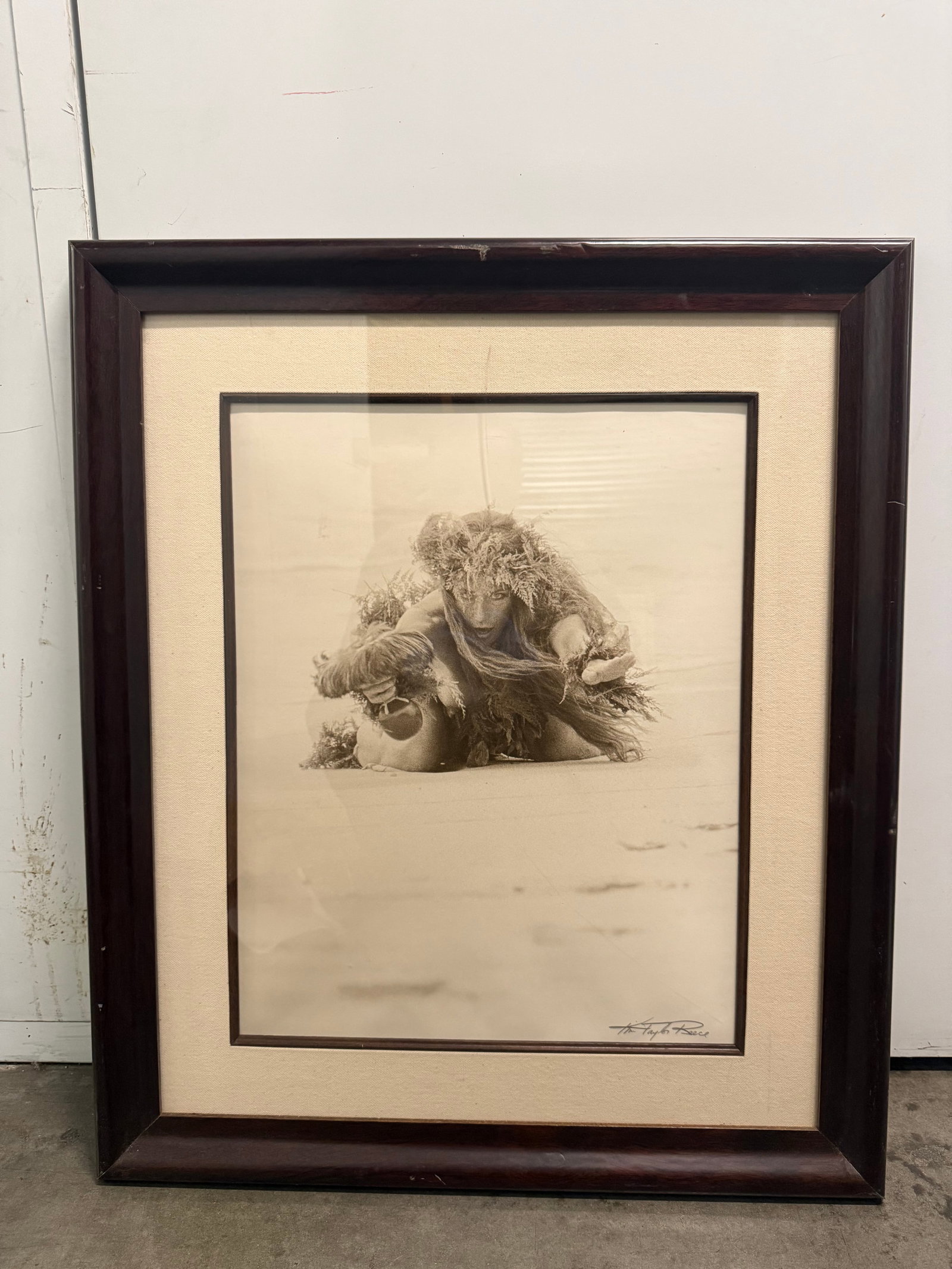 Kim Taylor Reece Framed Hula Print: Authentic Kim Taylor Reece sepia-toned hula photography print is professionally matted and framed. The artwork depicts a hula dancer in traditional attire. It is housed in a dark wood frame with a