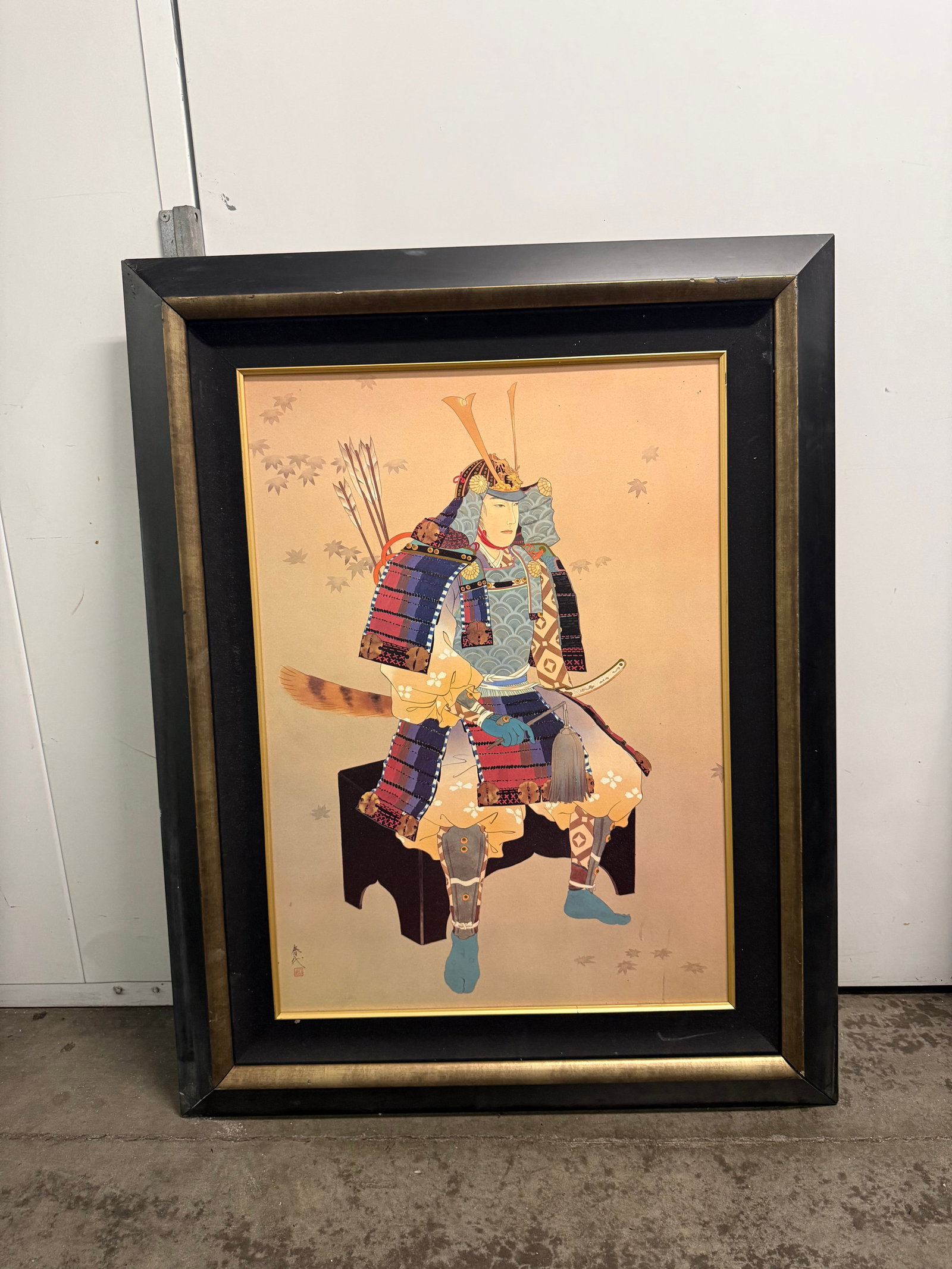 Framed Japanese Samurai Art Print. 42”x33”: Traditional Japanese samurai art print in a large black and gold frame. The artwork features a seated samurai in detailed blue, red, and gold armor with a bow and arrows. The background is a light tan