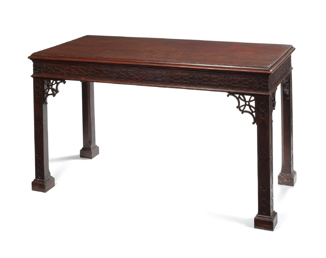 A George III mahogany blind fret carved serving table: A George III mahogany blind fret carved serving table after a design by Thomas Chippendale The rectangular moulded top above a blind fret carved frieze on square tapering chamfered and blind fret carv
