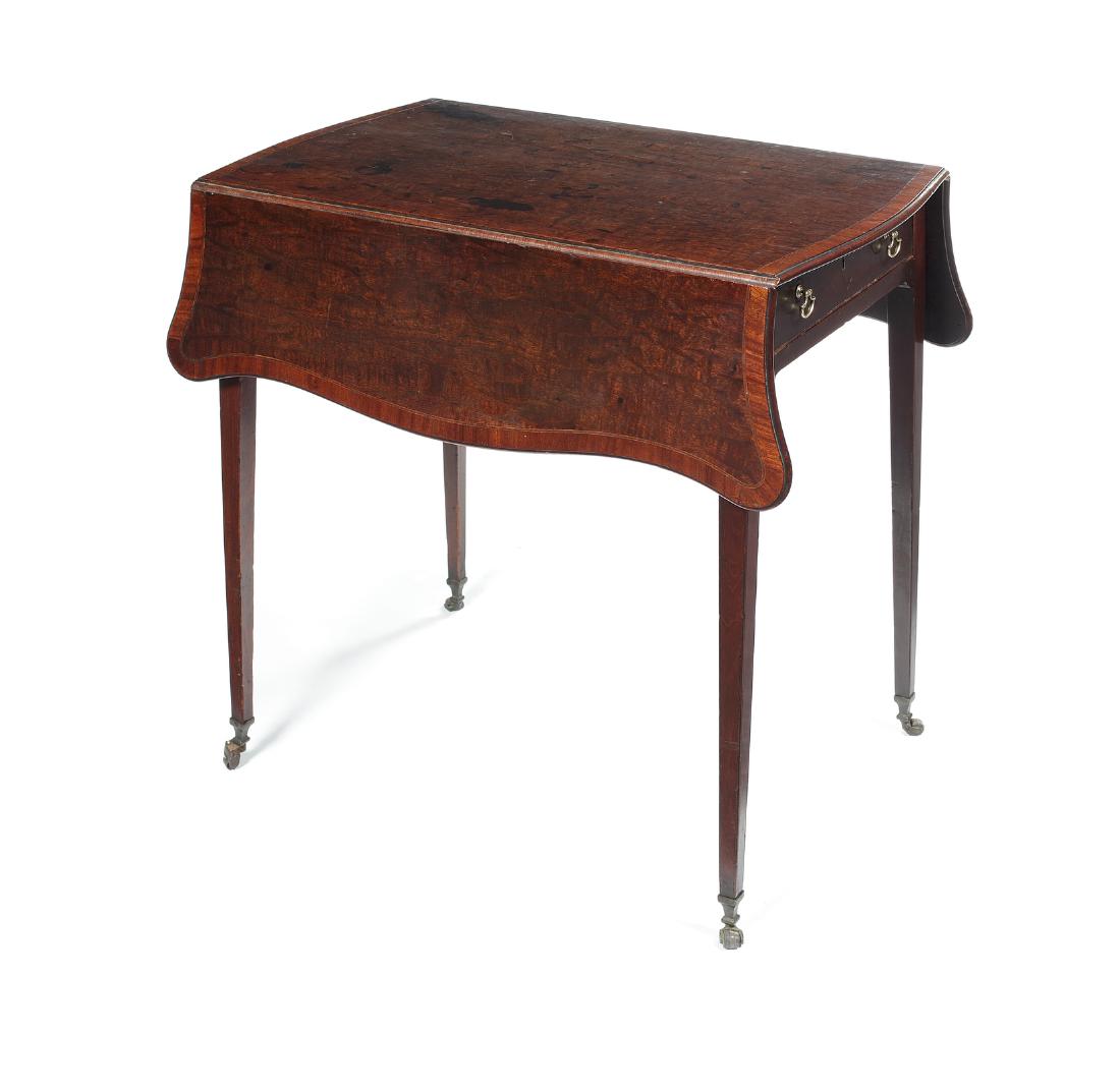 A George III figured mahogany Pembroke table: A George III figured mahogany and crossbanded serpentine Pembroke table in the manner of Thomas Chippendale in the French taste Inlaid with tulipwood banding, the shaped moulded top above a frieze dra