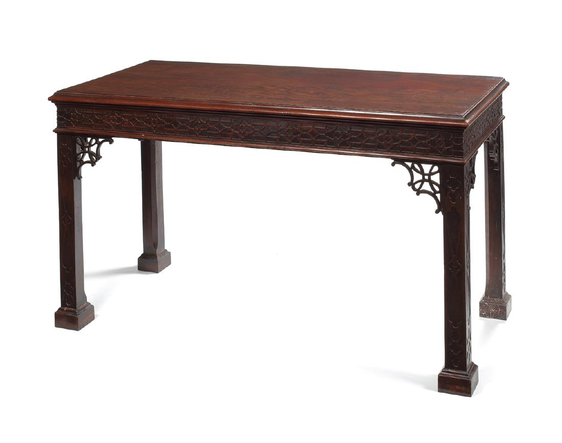A George III mahogany blind fret carved serving table: A George III mahogany blind fret carved serving table after a design by Thomas Chippendale The rectangular moulded top above a blind fret carved frieze on square tapering chamfered and blind fret carv