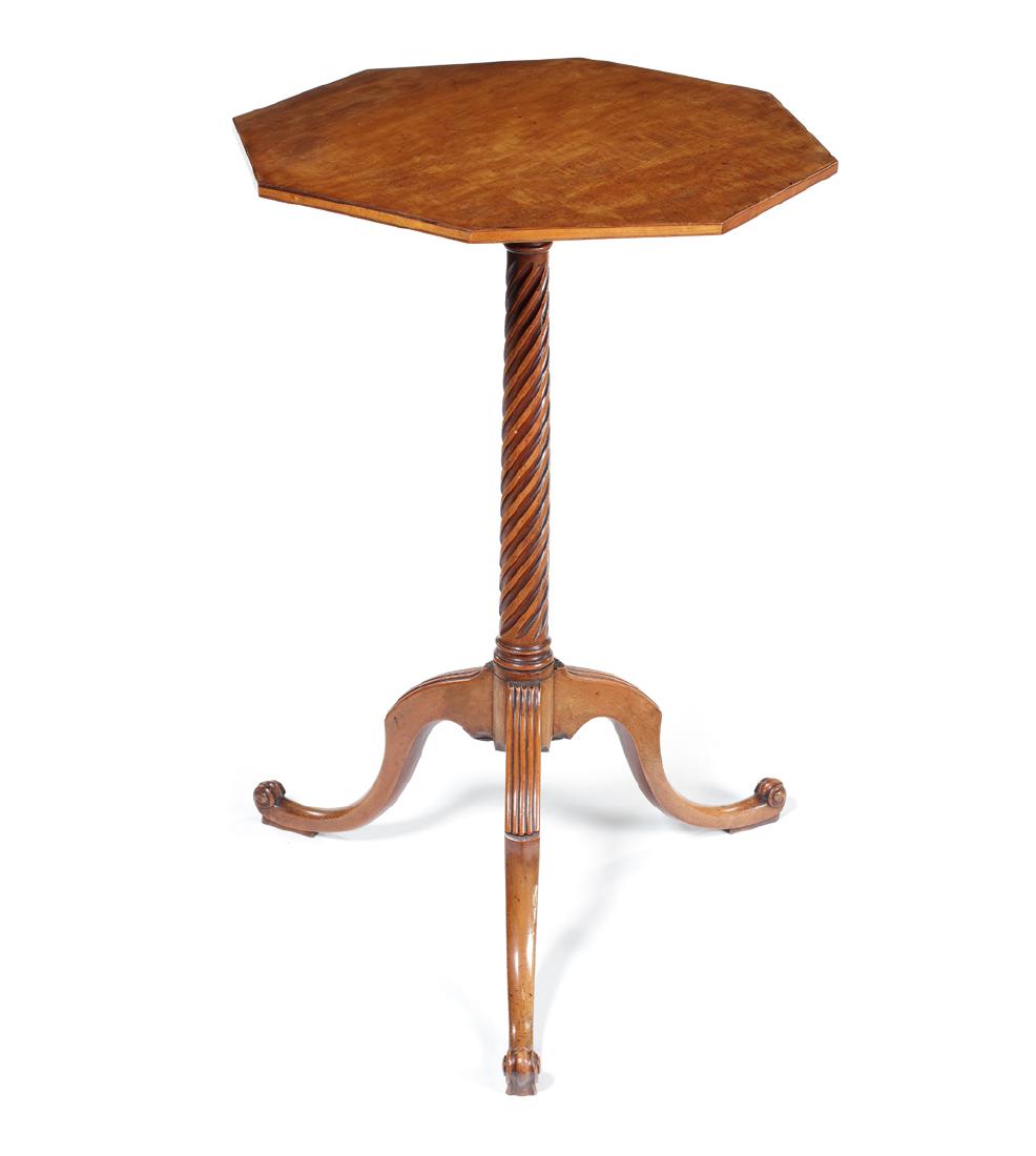 A George III satinwood octagonal tripod table: A George III satinwood octagonal tripod table in the manner of Thomas Chippendale The top on a wreathed shaft on hipped reeded downswept legs and scroll feet, 41cm diameter, 65cm high.