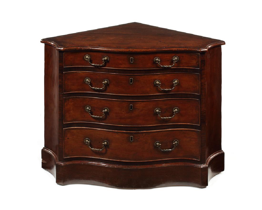 George III rosewood and sabicu serpentine corner chest: A George III sabicu and rosewood banded serpentine corner chest of drawers in the manner of Thomas Chippendale The shaped moulded top above four long graduated drawers with rosewood veneered angles a