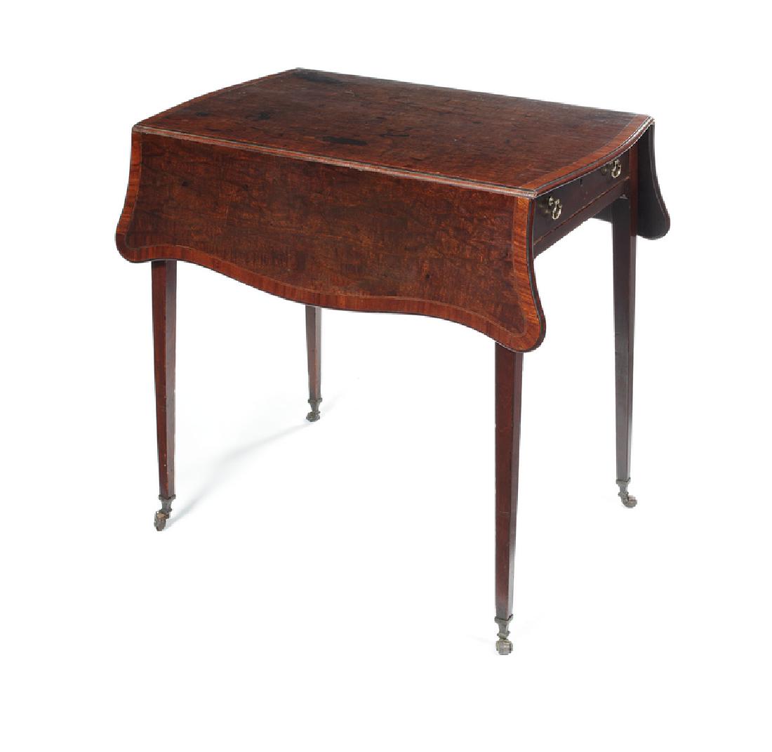 A George III figured mahogany serpentine Pembroke table: A George III figured mahogany and crossbanded serpentine Pembroke table in the manner of Thomas Chippendale in the French taste Inlaid with tulipwood banding, the shaped moulded top above a frieze dra