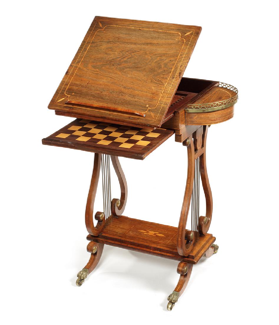 Regency rosewood games/work table: A Regency rosewood and tulipwood banded games/work table in the manner of John McLean The square hinged sliding ratcheted top with a removable book rest, enclosing an inlaid backgammon surface, flanke