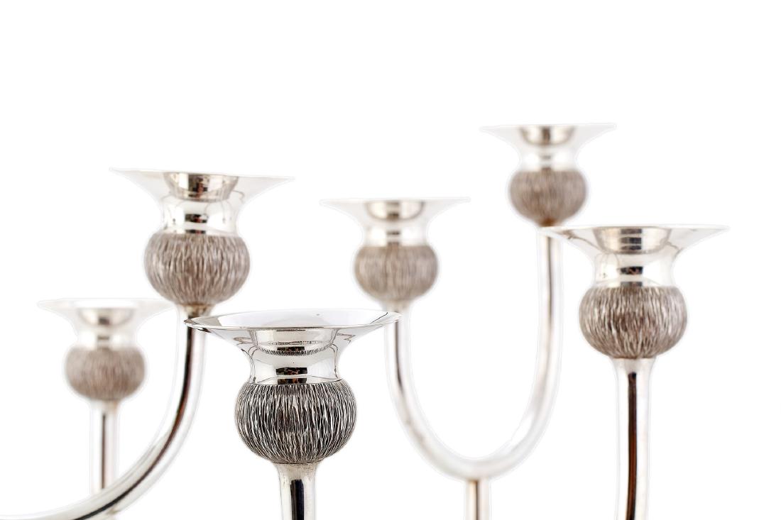 Nine-light silver candelabrum by Gerald Benney: An imposing nine-light silver candelabrum centrepiece by Gerald Benney, London, 1976 With six entwined bark-finish branches, each with detachable nozzles, and raised on seven conforming supports upon