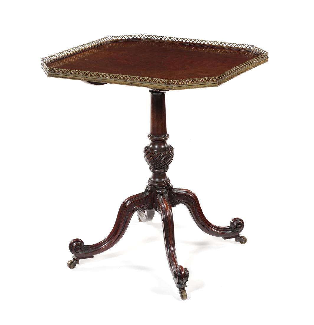 A fine George III carved mahogany centre table: A fine George III carved mahogany centre table in the manner of Thomas Chippendale The rectangular tilt top with canted angles and a later pierced gilt bronze gallery on a tapered ring turned and wryt