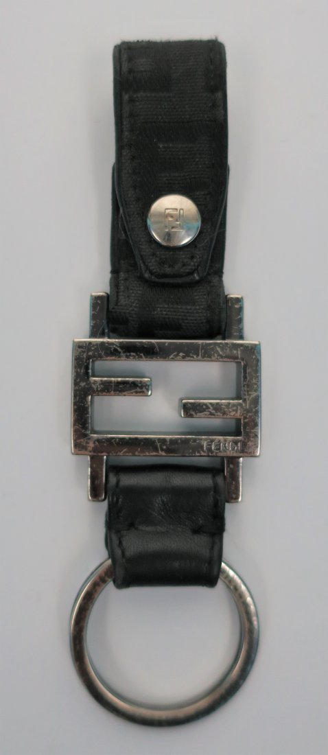 FENDI Keychain: An authentic black and metal FENDI keychain. Keychain is chrome, canvas, and leather.
