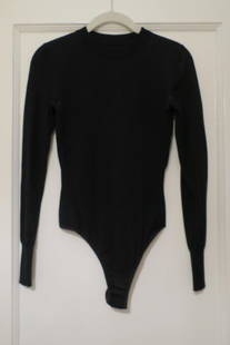 Azzedine ALAIA, Paris: Jet Black Knit Top/Bodysuit with thong bottom with snaps. Marked 'Made in Italy'. Size 38. (Piece is jet black, camera flash distoring color.)