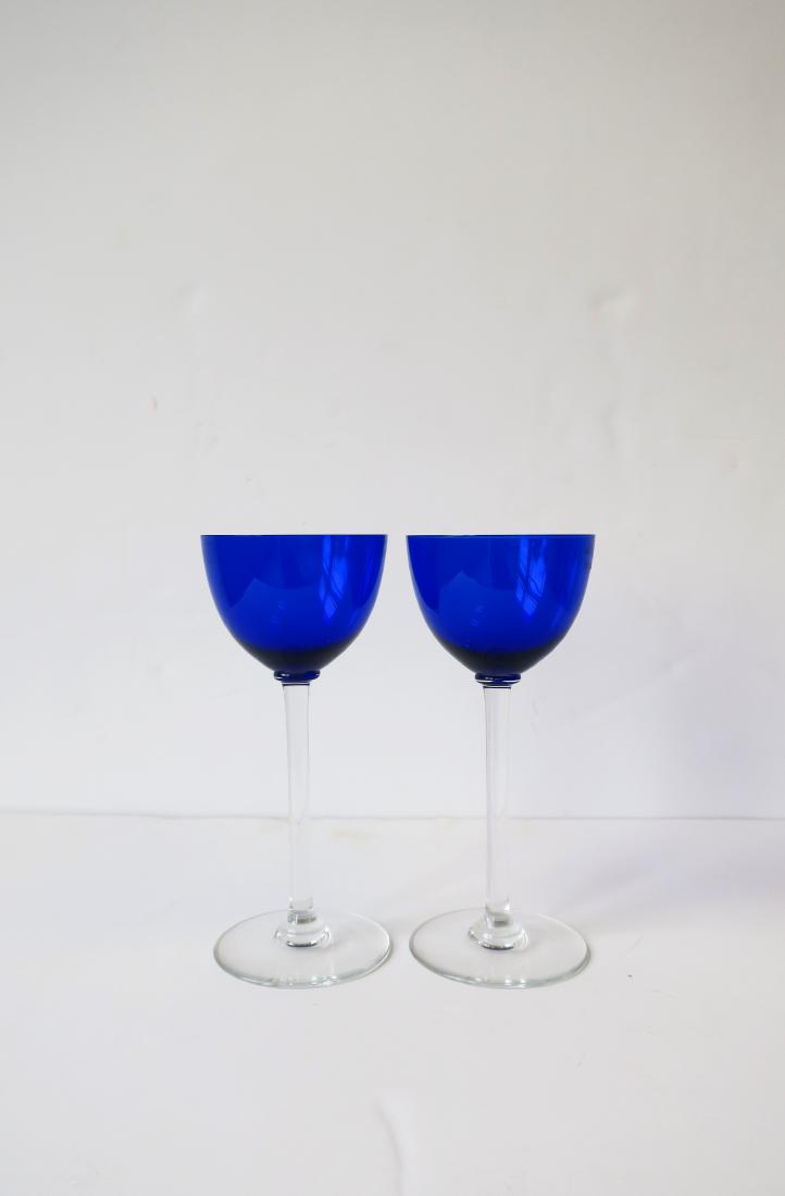 Baccarat Wine Glasses, pair: Set of two French cobalt blue and clear crystal wine or water glasses by luxury maker Baccarat. Hand-crafted crystal glasses are 7.5 inches tall. Made in France. With maker's mark on bottom. No buyers