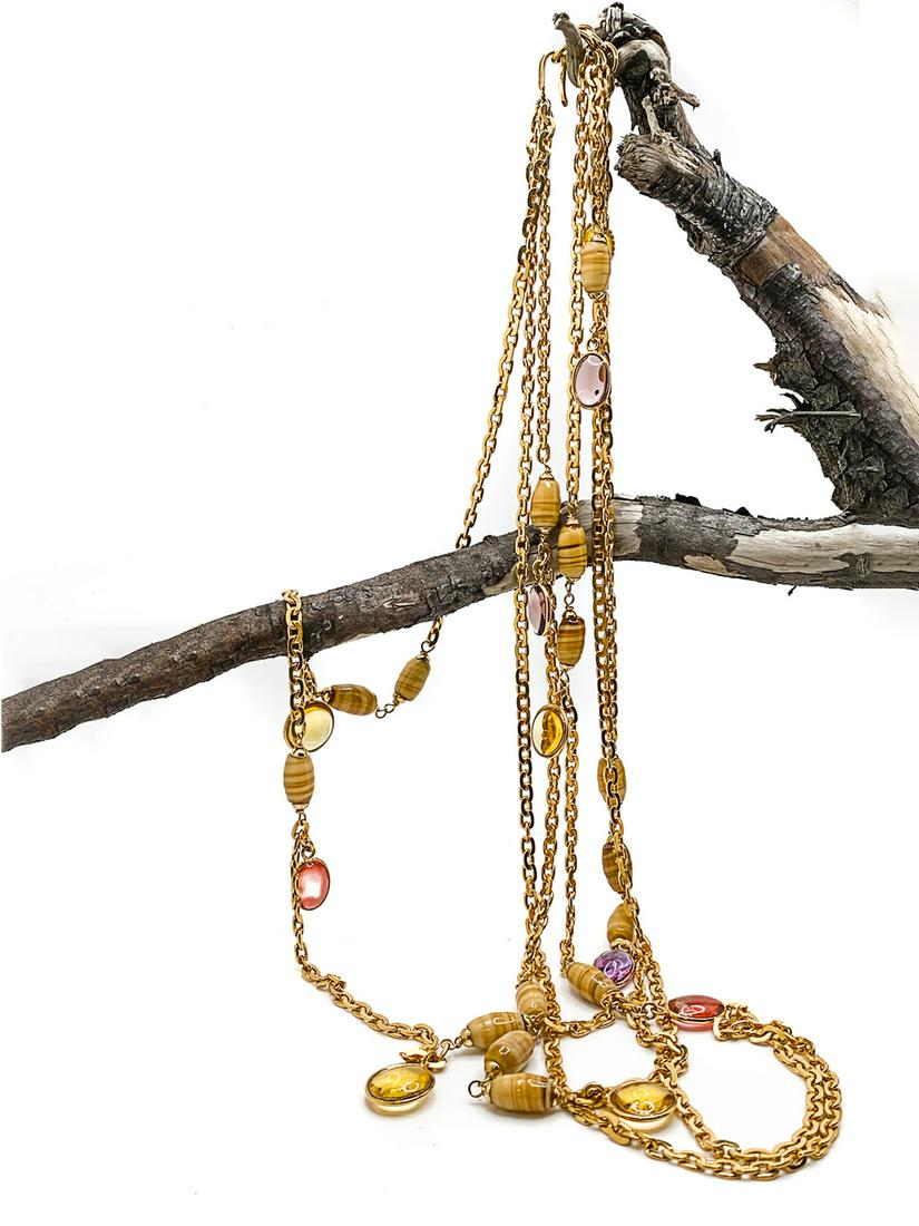 Chanel Classic Necklace.: Necklace with three flat laced gilt chains, in different length, with alternated patterns of glass beads, in solid and translucent colors. Signed in oval tag: Chanel Made in France. Full Length 29 inc