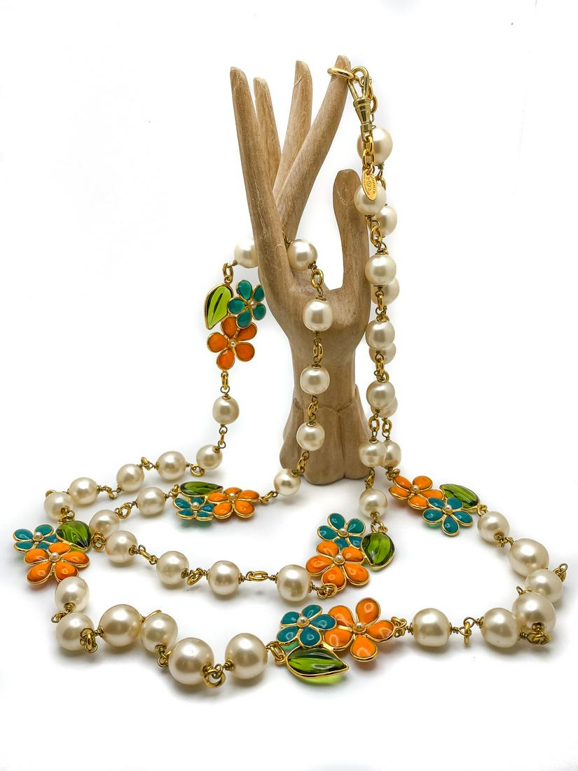 Chanel Sautoir glass and pearls necklace.: One string of Baroque faux pearls spaced with gilt findings, in an alternate pattern with a flowers decor in glass and gilded metal. Oval tag signature: Chanel Made in France. Full Length 58 inches