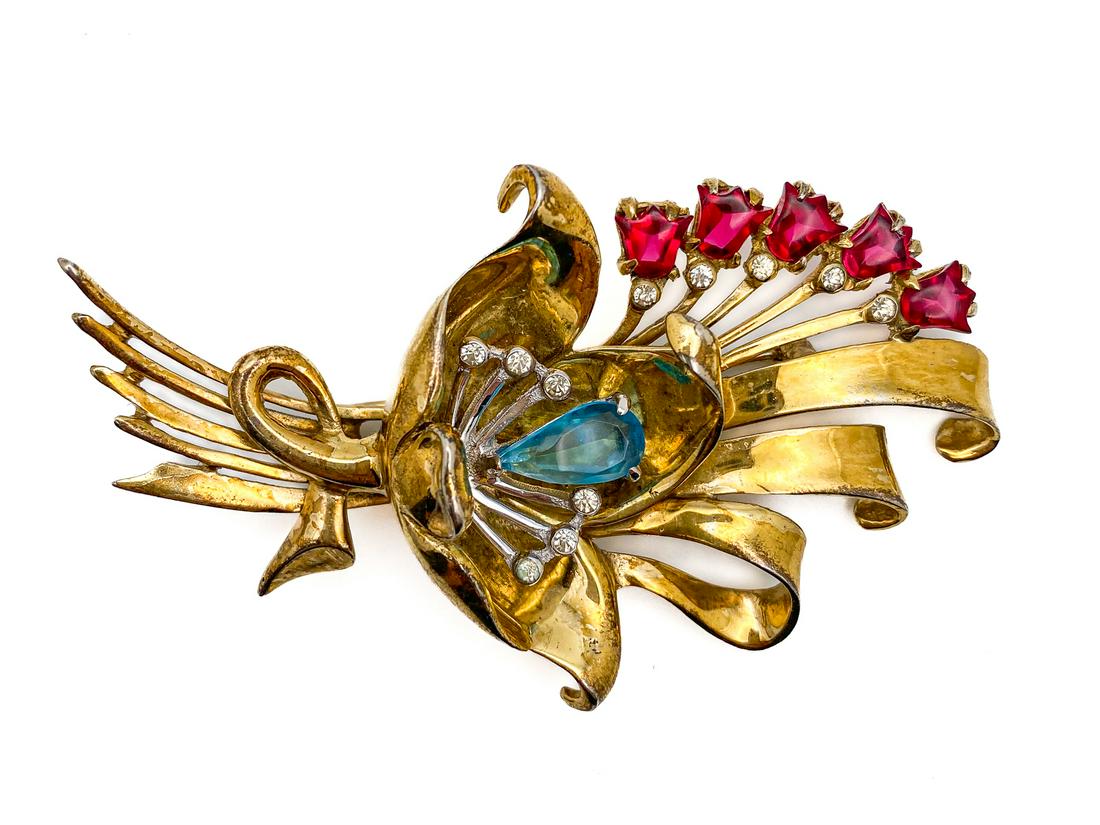 Ralph DeROSA Rhinestones Brooch.: Vintage 1940 circa. Brooch in gilt sterling metal designed as a bouquet of flower and swirls with ruby aqua and clear rhinestones. Fade mark on the back STERLING â€“ R DeROSA H 3 ½” 