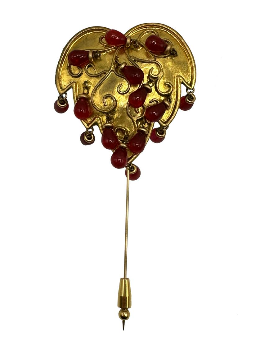 Isabel Canovas Pin Brooch.: Pin brooch in gilt metal designed in between of a leave and a heart, with embossed swirls and dangling translucent carnelian beads. Signed on the back. Dimension 2x2 long pin 3”