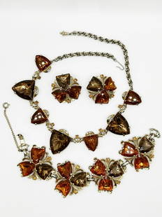 Elsa Schiaparelli Parure Necklace, Earrings, and Bracelet.: Costume parure decorated with pendants in shape of shields, of amber and brown color, and small amber rhinestones. All pieces signed "Schiaparelli" signature on the earring faded. Full length Necklace