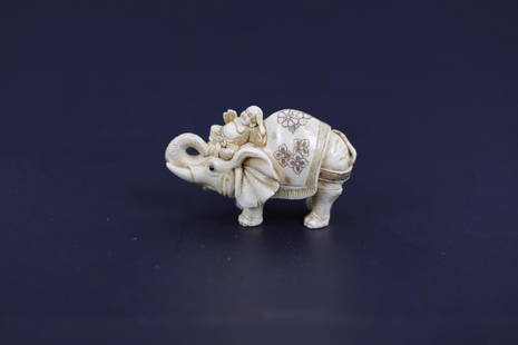 A Carved Netsuke of Hotei Riding An Elephant Signed: A Carved Netsuke of Hotei Riding An Elephant Signed. H: 1.5 W: 2 Inches