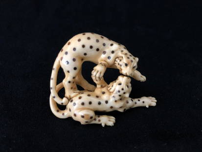 A Cattle Bone Carved Netsuke of a Panther Couple: A Cattle Bone Carved Netsuke of a Pair of Panther Couple. H: 1.5" in. (3.8 cm.) W: 2" in. (5.1 cm.) D: 0.8" in. (2.3 cm.)