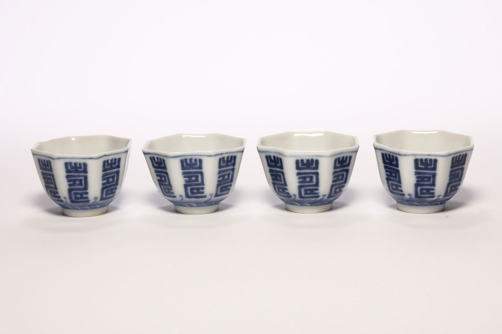 A Group of Four Blue and White LONGEVITY Cups: A Group of Four Blue and White LONGEVITY Cups. H: 1.3 in. (3.5 cm) D: 1.8 in. (4.8 cm)