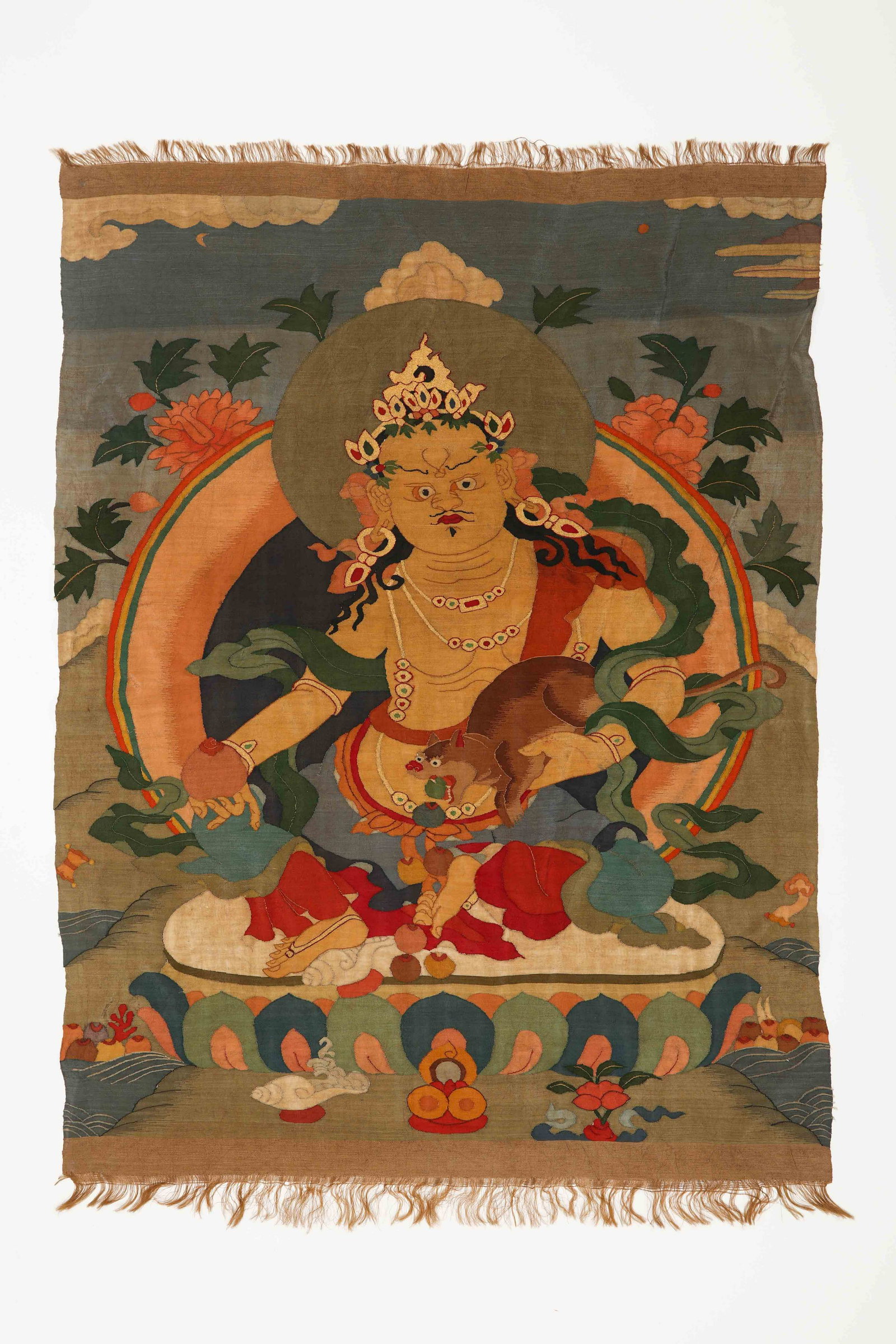An Embroidered Kesi Thangka Of Jambhala: An Embroidered Kesi Thangka Of Jambhala. H: 39.3 in. (100 cm) D: 29.5 in (75 cm)