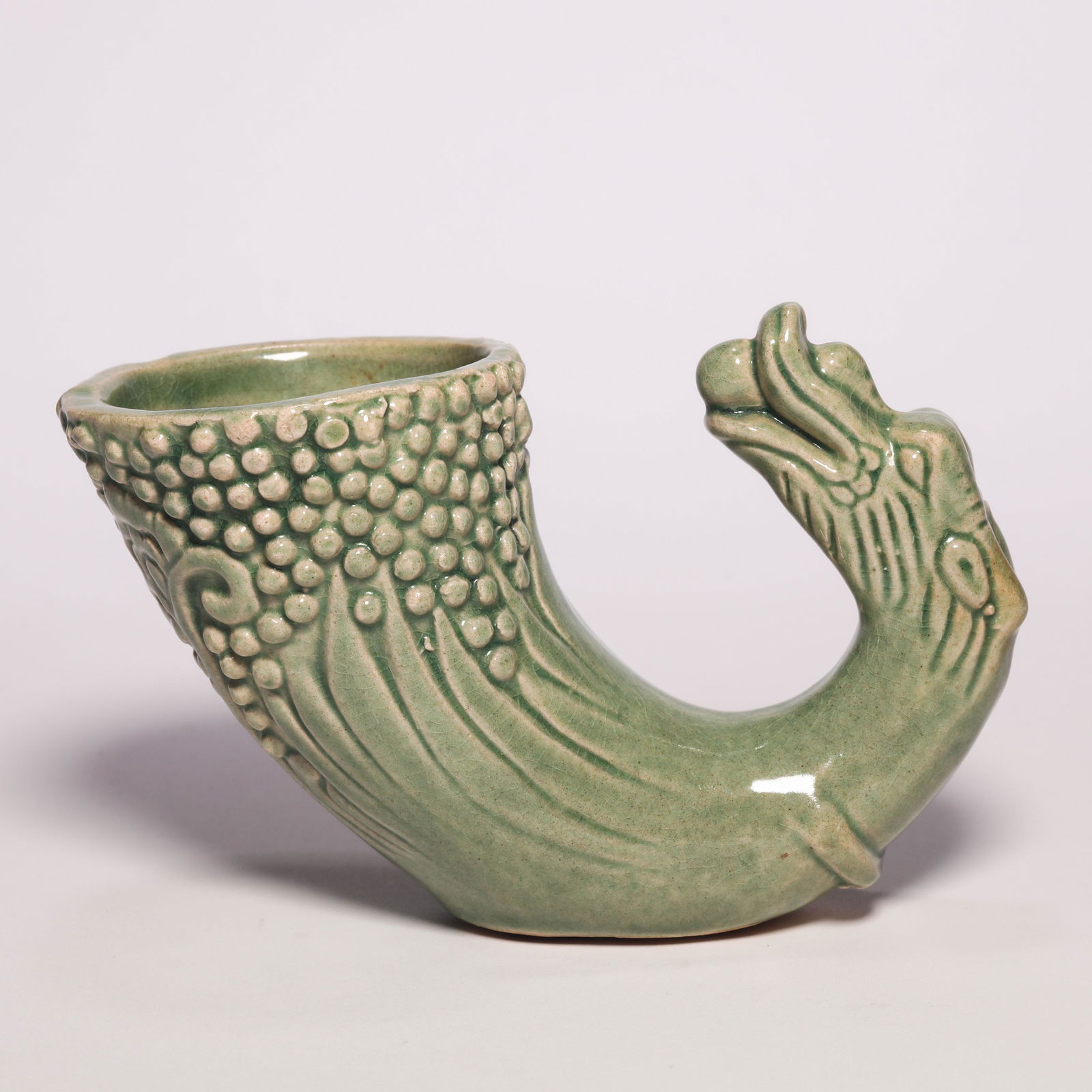 A Green Glazed Dragon-Form Cup: A Green Glazed Dragon-Form Cup. H: 3.1 in. (8 cm) W: 5.1 in (13 cm) D: 2.4 in (6.3 cm)