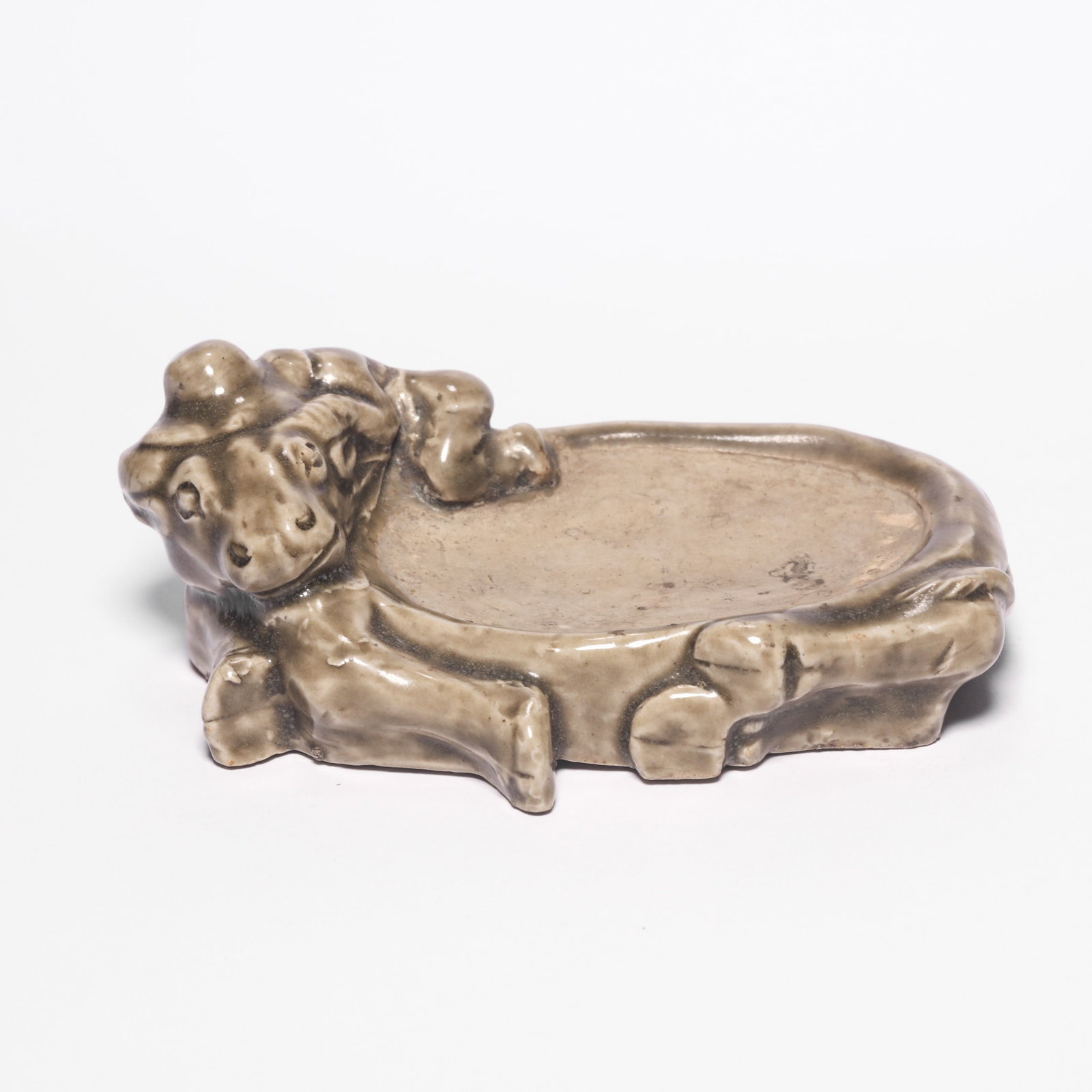A Changsha Ware Ox and Child Inkstone: A Changsha Ware Ox and Child Inkstone. H: 1.6 in. (4 cm) D: 5 in (12.5 cm)