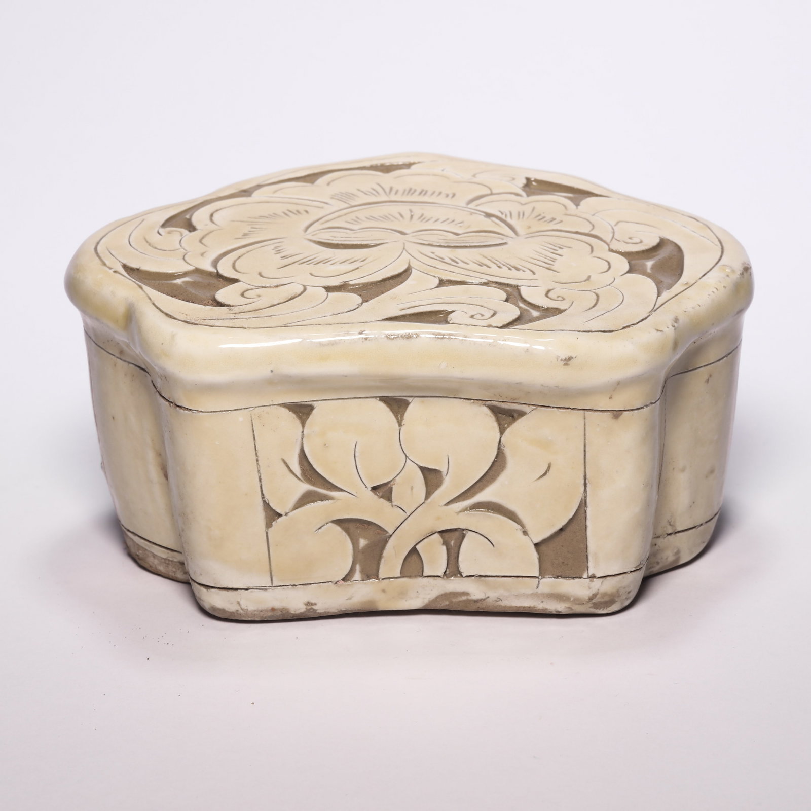 A CiZhou White Porcelain Carved Pillow: A CiZhou White Porcelain Carved Pillow. H: 3.1 in. (8 cm) W: 6.3 in (16 cm)