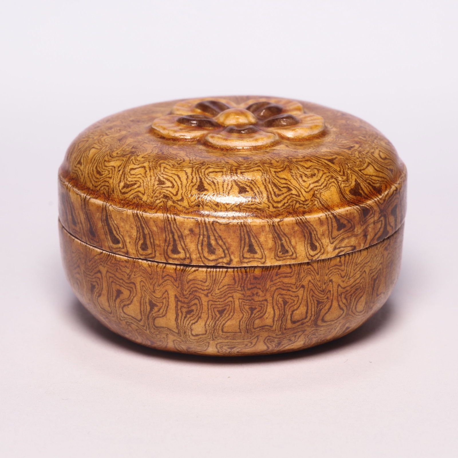 A Yellow-Glazed Marbled Pottery Carved Flower Powder Box: A Yellow-Glazed Marbled Pottery Carved Flower Powder Box. H: 1.6 in. (4 cm) D: 2.5 in. (6.5 cm)