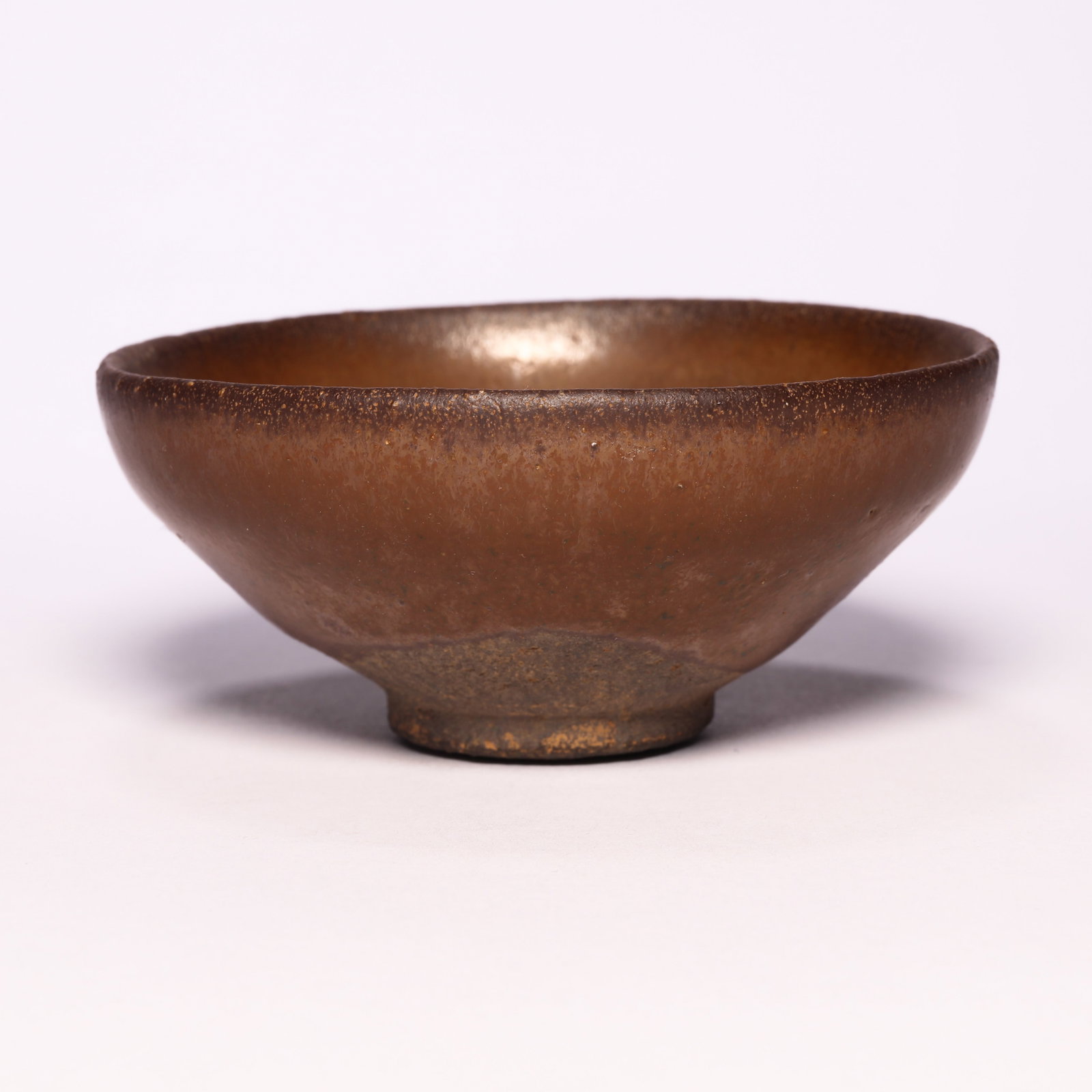 A Jian Ware Russet-Glazed Tea Bow: A Jian Ware Russet-Glazed Tea Bow. H: 1.6 in. (4 cm) D: 3.5 in. (9 cm)