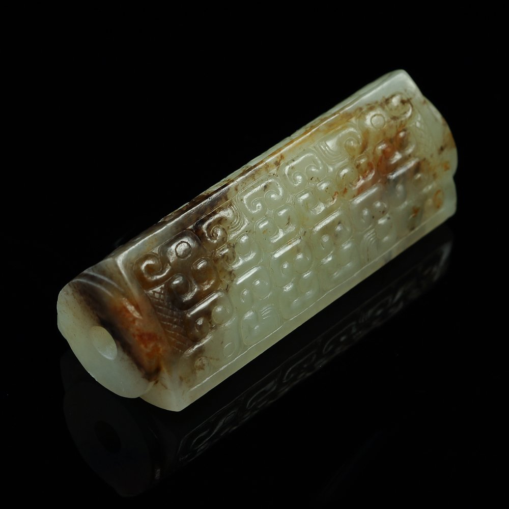 Antique Chinese Hetian jade adornment: Antique Chinese Hetian jade adornment; the adornment has the shape of a hollowed circle inscribed in a triangle;Length: 2.11 x 0.76 x 0.76".