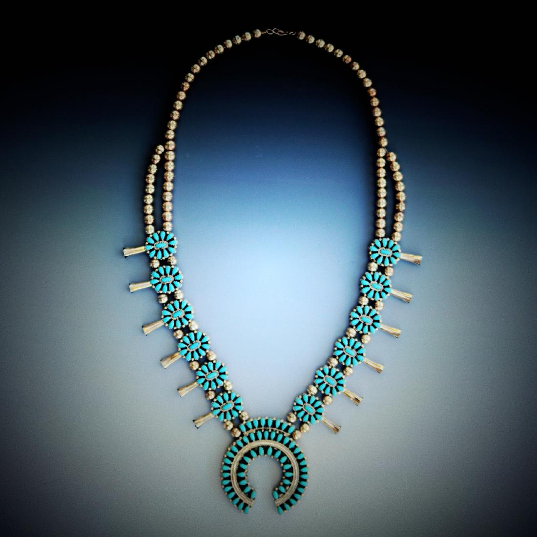 Squash Blossom Necklace Sleeping Beauty Turquoise/Red C: Description: This is an exceptional and very striking squash blossom necklace. It is museum quality. Two sides are embedded with gemstone and total weight 140g. Length please refer to the picture. It'