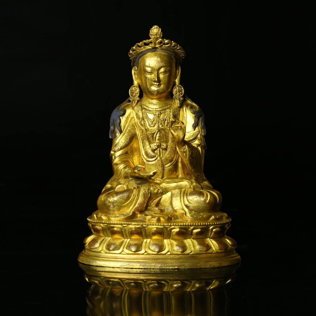 A CHINESE GILT BRONZE VAIROCANA BUDDHA: A CHINESE GILT BRONZE VAIROCANA BUDDHA;[H]6" [W] 5", 2550g.