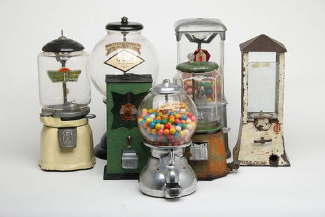 Mixed Lot Seven Candy Gumball Nut Vending Machines: Mixed lot of seven tabletop vending machines of various makers and contents. Measurements range from 11" high to 16" high. Property from the estate of Walt Disney Imagineer John Patrick Burke.