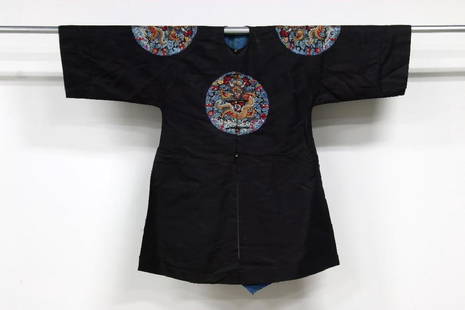 Chinese Embroidered Black Surcoat Imperial Dragon Robe: Black Chinese robe with button front and embroidered dragons front and back, on each shoulder. High side and back slits with blue silk lining. 44" long, 52" chest.