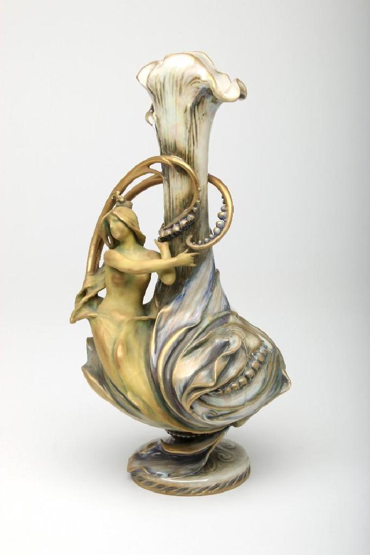 RStK Amphora Eduard Stellmacher Lily Valley Maiden Vase: Eduard Stellmacher (1868 - 1929) figural vase with maiden and lily of the valley, marked Amphora, RStK. Height 14".