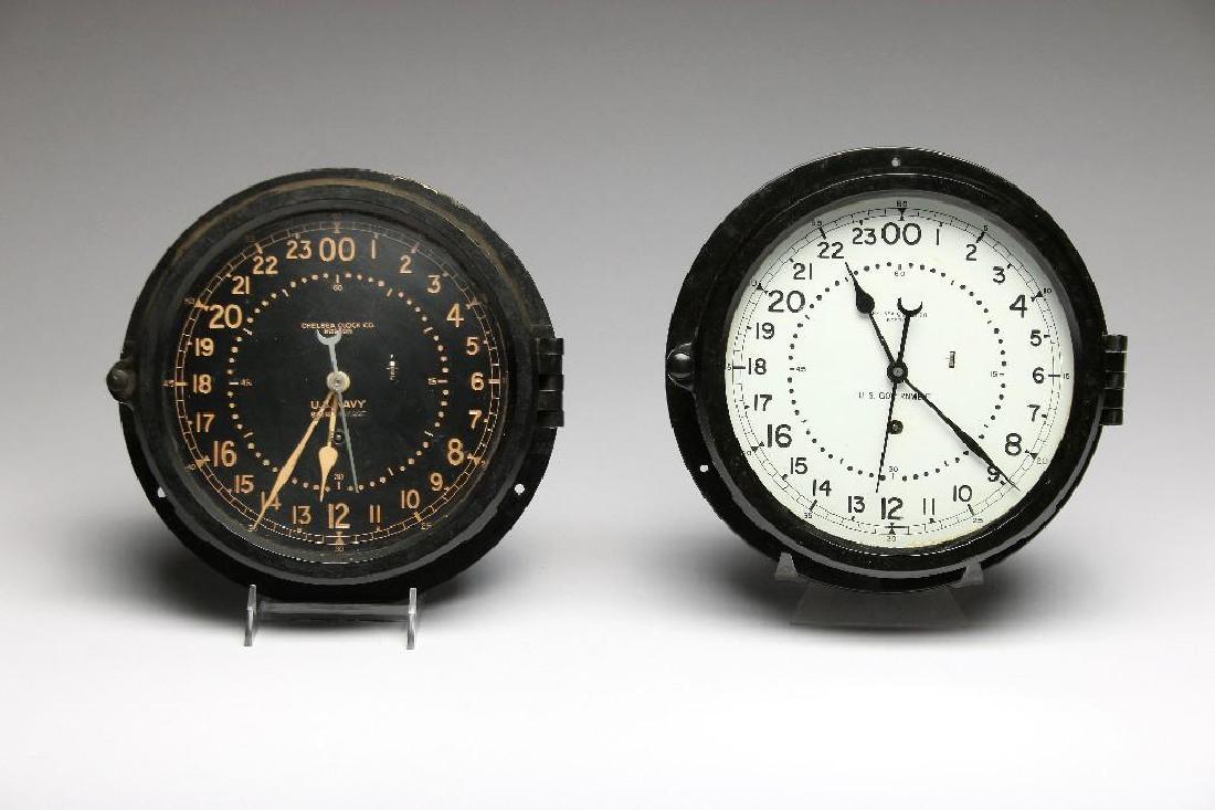 Two Vintage WWII era Chelsea Boston 24 Hour Ships Clock: Two vintage 24 hour clocks, Chelsea Clock Co., Boston. Black with black face and black with white face clocks. Both measure 10 1/4in. diameter x 3in. H.